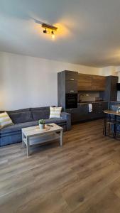 a living room with a couch and a table at Riverside Vrchlabí in Vrchlabí