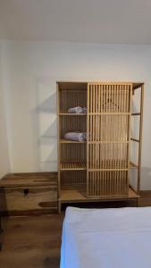 a room with a wooden cage next to a bed at Riverside Vrchlabí in Vrchlabí