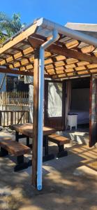 a wooden picnic table under a pavilion at Westbrook Hideaway in Westbrook