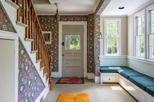 a hallway with a blue bench in a house at Antique Charmer Walk to Downtown KBK in Kennebunk