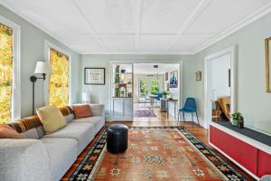 a living room with a couch and a rug at Antique Charmer Walk to Downtown KBK in Kennebunk