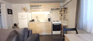 a kitchen with a white refrigerator and a stove at West Garden At Aigio By Greece Apartments in Aigio
