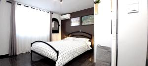 a small bedroom with a bed in a room at West Garden At Aigio By Greece Apartments in Aigio