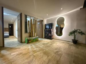 a living room with a tv and a room with at Carriqui Garden Hotel in Pereira