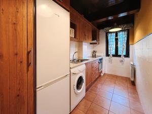 a kitchen with a refrigerator and a washing machine at Casa Puerta de Albarracín in Albarracín