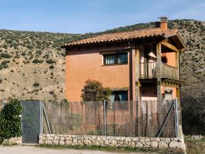 a house with a fence in front of a hill at Casa Puerta de Albarracín in Albarracín