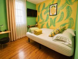 a couch in a room with a green wall at Lemon Vibes room in Guesthouse in New York
