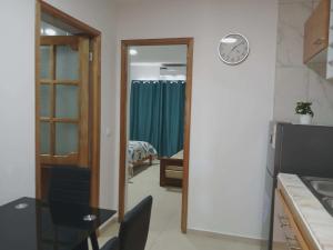 a room with a clock on the wall next to a bedroom at Vivenda Carlos Daniel in Espargos