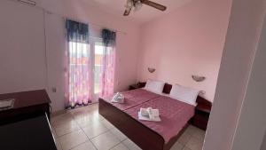 a bedroom with a bed with two towels on it at Konak Vukojević in Šušanj