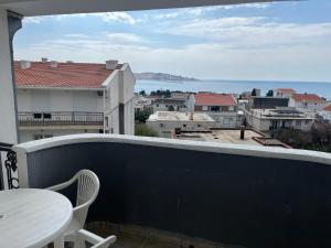 a balcony with a table and a view of the water at Konak Vukojević in Šušanj