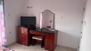 a dressing table with a mirror and a television at Konak Vukojević in Šušanj
