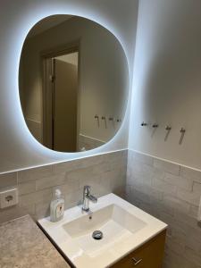 a bathroom with a sink and a mirror at Modern Apartment i Solna in Solna +22 photos