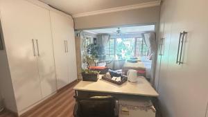 a room with a kitchen and a living room at Artzy's Garden View 1km to Olivedale Clinic in Northriding
