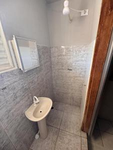 a bathroom with a sink and a shower at Pousada Torre dos Mouros in Pirenópolis