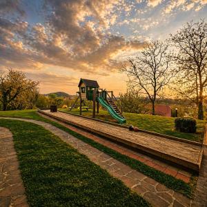 a playground with a slide in a park at Adventure Farm in Štore