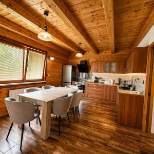a dining room with a table and chairs in a kitchen at Adventure Farm in Štore