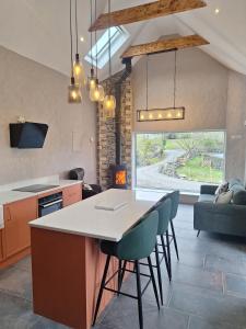 a kitchen and living room with a table and chairs at Sunny Hills Cottage in Cornamona
