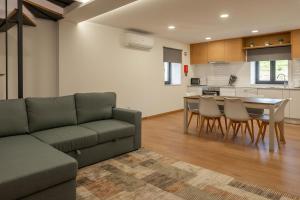 a living room with a couch and a table and chairs at Casa do Formão in Amarante