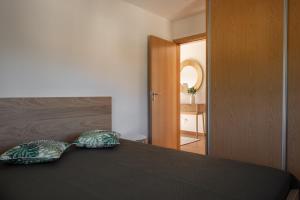 two pillows sitting on a bed in a bedroom at Casa do Formão in Amarante