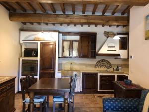 a kitchen with a wooden table and a dining room at Casa Varna in Gambassi Terme