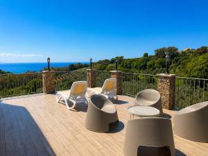 a patio with chairs and tables and the ocean at Casale Calabria in Gizzeria +142 photos