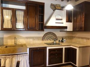 a kitchen with wooden cabinets and a sink at Casa Varna in Gambassi Terme +105 photos