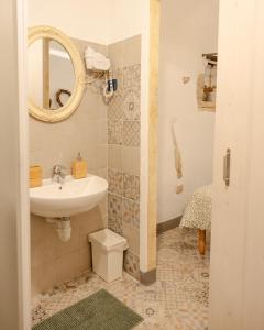 a bathroom with a sink and a mirror at Agriturismo Alveare in Finale Ligure +48 photos
