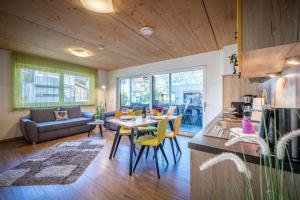 a kitchen and living room with a table and chairs at Alpenapart Singer - contactless check-in in Reutte