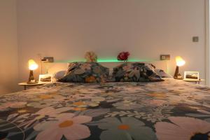 a bedroom with a bed with a comforter and two lamps at Puerta de Arcos in Arcos de la Frontera