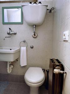 a bathroom with a white toilet and a sink at Nel Cuore di Lanciano - WeclHome in Lanciano +12 photos