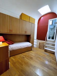 a small room with a bed and a staircase at Nel Cuore di Lanciano - WeclHome in Lanciano