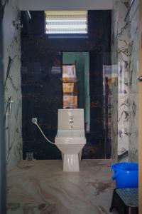 a bathroom with a white toilet in a room at Kheya Tori Resort in Tajpur +20 photos
