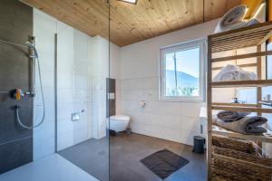 a bathroom with a glass shower and a toilet at Alpenapart Singer - contactless check-in in Reutte +106 photos