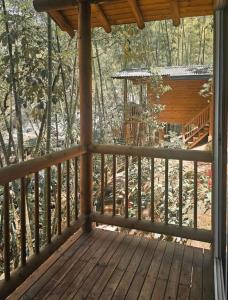 a porch of a cabin with a gazebo at La Chorrera ecohotel in Cocorná +3 photos