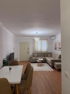 a living room with a couch and a table at Blendi Guest House in Golem