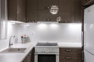 a kitchen with a stove and a sink at Volos Comfort Stay with free parking in Volos