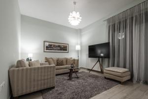 a living room with a couch and a tv at Volos Comfort Stay with free parking in Volos