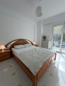 a bedroom with a wooden bed in a room at Meltemi Evia in Paralía