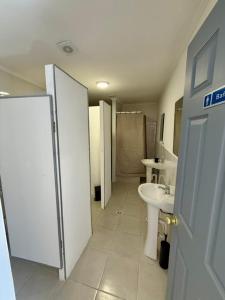 a bathroom with a sink and a toilet and a sink at Casa Hostal , Mejillones in Mejillones
