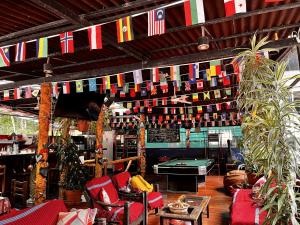 a room with flags and a pool table at Nativus Hostel Machu Picchu in Machu Picchu +78 photos