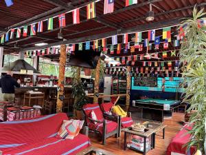 a bar with chairs and a pool table and flags at Nativus Hostel Machu Picchu in Machu Picchu