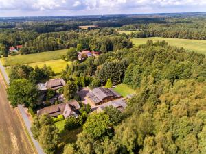 an aerial view of a house in the forest at AMAYA Hotel & Suites Soltau in Soltau