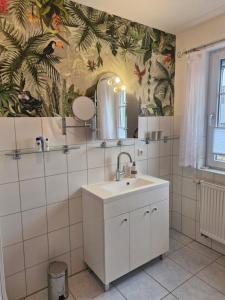 a bathroom with a sink and a mirror at Lilly & Fine in Zingst +56 photos