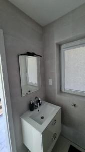 a bathroom with a sink and a mirror and a window at U Znajomych in Wołkowyja +35 photos