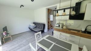 a kitchen and a living room with a table at U Znajomych in Wołkowyja