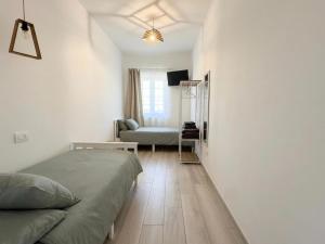 a bedroom with a bed and a couch in a room at b&b Il Margonico in Potenza