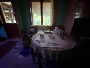 a room with a table in a room with a window at Kazanlak SHELTER HOUSE ACCOMODATION 1 Room 1 Bed, No Water, WC is Outhouse, Dirt Road, Dog in the Garden, Genius Points Welcome! Къща за Подслон в Казанлък, Без Вода! in Kazanlŭk