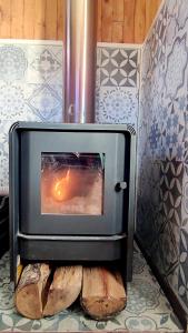 a stove with a fire in it in a room at Victoria Cabin in Victoria