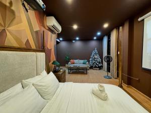 a bedroom with a christmas tree and a bed at Uh Homestay Thảo Điền in Ho Chi Minh City