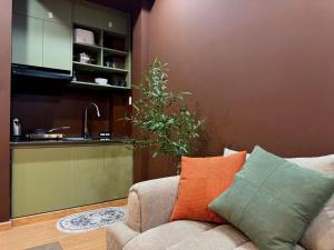 a living room with a couch and a kitchen at Uh Homestay Thảo Điền in Ho Chi Minh City +23 photos